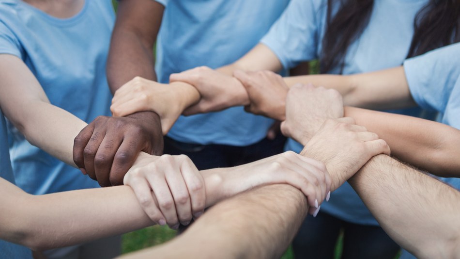 hands-of-young-people-joined-in-circle-AHUPBXC.jpg